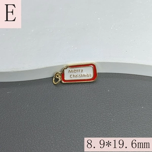Detail of Merry Christmas pendant with red enamel border and gold ring for DIY jewelry