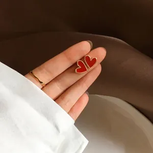 Elegant S925 silver heart earrings with dark green enamel and gold-plated borders