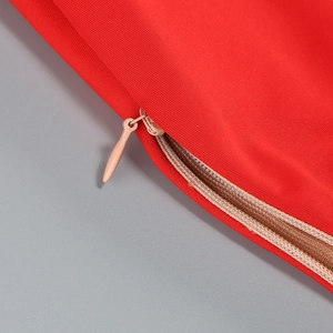 Close-up of invisible zipper and red mesh fabric detail on high waist dress