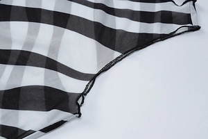Detailed close-up of the black and white checkered sheer mesh fabric and stitching