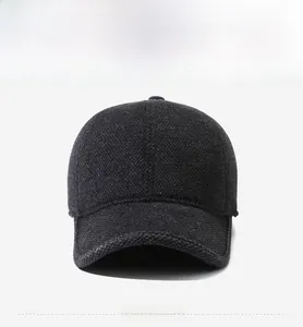 Detail of wool blend winter baseball cap featuring a shield metal F logo in dark grey