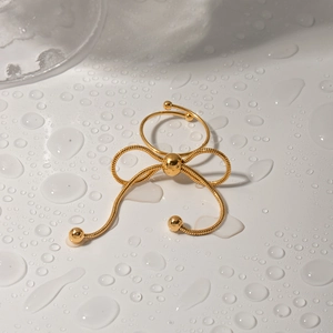Close-up of golden butterfly snake chain adjustable ring with polished metal beads