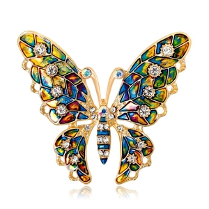 Elegant gold butterfly brooch with colorful enamel wings and sparkling diamond accents