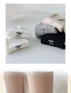 Detail view of bow embroidery on ribbed knit cotton socks and thermal leggings