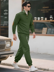 Detail of dark green tracksuit featuring diamond knit texture and elbow patch details