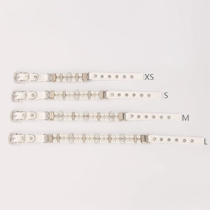 Detail view of white pearl pet collars with rhinestone accents in XS to L sizes
