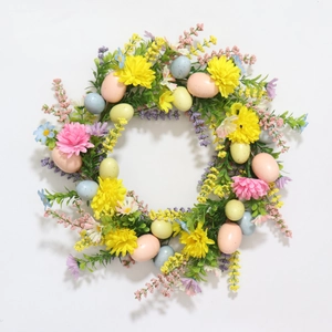 Easter floral wreath with colorful eggs, yellow daisies, and green leaves on white background