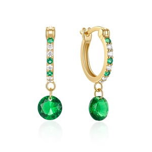 Detailed shot of golden s925 silver hoop earring with faceted emerald gemstone charm