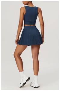 Rear view of navy blue yoga set showing waist-shaping top and pleated tennis skirt
