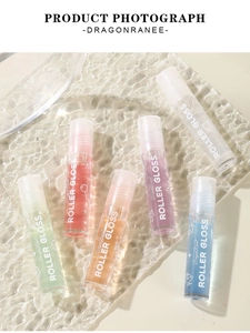 Close-up of six-piece roller lip gloss set on clear water ripple tray