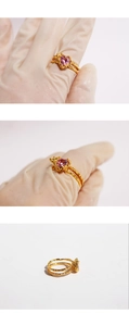 Detailed views of gold open ring featuring a pink heart zircon on textured split band