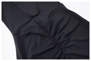 Detailed view of the ruched design and smooth elastic knit fabric on a black yoga bodysuit