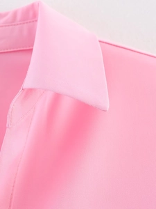 Macro shot of pink drawstring shirt collar and shoulder seam with twill texture