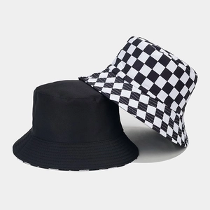 Detail of reversible bucket hat in black cotton and classic checkerboard pattern fabric