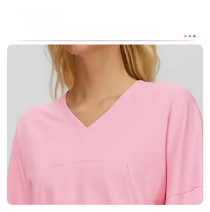 Close-up of pink V-neck hoodie showing detailed knit texture and collar stitching