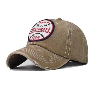 Macro shot of khaki washed cotton baseball cap featuring vintage distressed brim detail