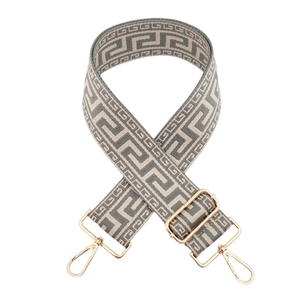 Detailed view of grey and white meander patterned strap with golden metal swivel hooks