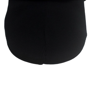 Close-up of the black knit fabric showing detailed fine stitching on the beanie
