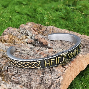 Viking Mjolnir Thor Hammer cuff bracelet with rune carvings on rustic tree bark background