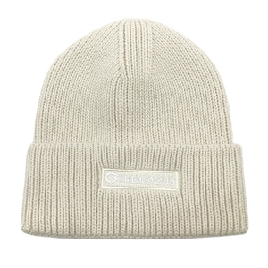 Close-up of off-white ribbed knit beanie featuring the FOCUS brand patch on the cuff