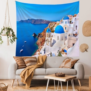 Santorini wall tapestry featuring blue-domed churches over a modern living room sofa