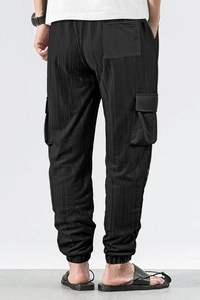 Detailed back view of black checkered cargo joggers featuring functional rear pockets