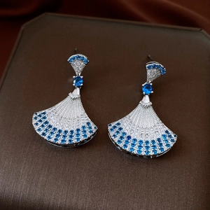 Close-up of fan-shaped drop earrings with deep blue and white pave rhinestones