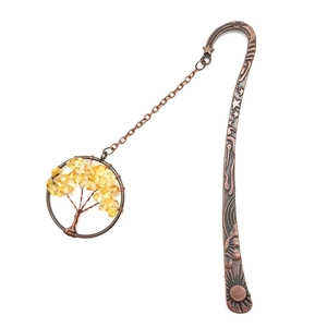 Detailed close-up of a vintage bronze tree of life bookmark with yellow crystal stones