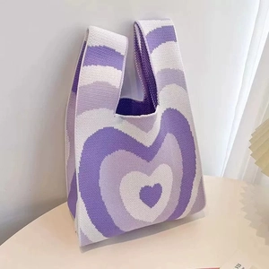 Detail of purple and white heart pattern on knitted tote bag with soft texture
