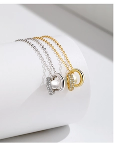 Detail of elegant silver and gold pearl circle pendants with sparkling zircon stones