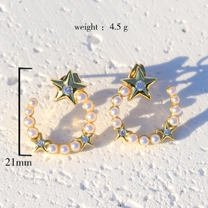 Elegant gold plated star and moon earrings with micro-set zircon and pearls on white background