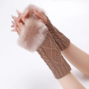 Detail of cable knit fingerless gloves in brown with fluffy faux fur wrist cuffs
