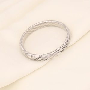Close-up of silver-tone stainless steel Tubogas bracelet showing elastic snake chain texture