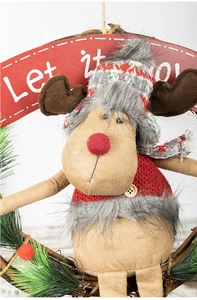 Detail of Christmas reindeer wreath featuring a Let It Snow banner and knit scarf decor