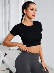 Detail of black ribbed knit short sleeve crop top for yoga and fitness workout