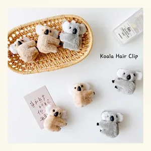 Cute 3D plush koala hair clips in grey and brown for women's creative hairstyling