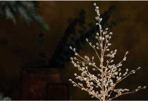 Close-up of champagne gold acrylic Christmas branch with crystal bead decorations