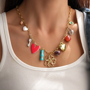 Detail of a gold-tone necklace with colorful resin heart charms and a key pendant