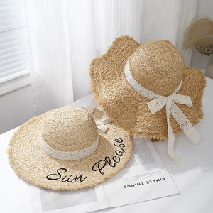 Beige raffia sun hats with black Sun Please embroidery and white lace ribbons