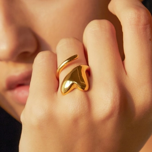 Detailed view of the 18k gold organic fluid shape ring with a modern liquid metal texture