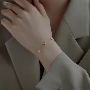 Elegant gold butterfly bracelet with zircon crystals worn on a model's wrist