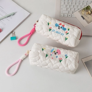 Detail of heart quilted pencil case with cute dog embroidery and pink carrying handle