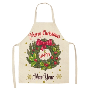 Detail of Christmas apron with Merry Christmas wreath print on beige cotton fabric