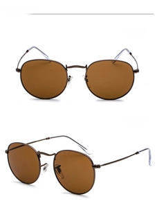 Macro view of retro round metal sunglasses with brown frames and tinted lenses