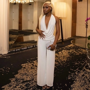 Women's white halter neck jumpsuit with a deep V-neck and elegant draped fabric