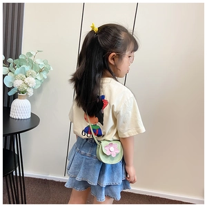 Detail of light green flower shoulder bag for girls worn with casual stylish outfit