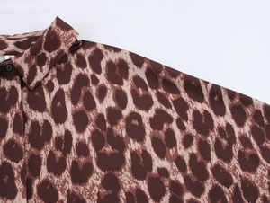 Close-up of leopard print shirt collar and fabric texture in brown and beige tones