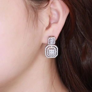 Elegant silver geometric earrings with octagon zircon pave worn by a model