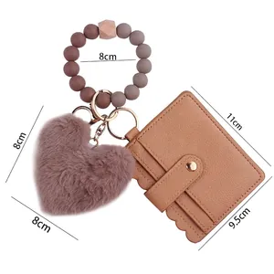 Silicone bead wristlet with plush heart charm and brown leather card holder keychain