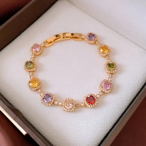 Detail of 18k gold-plated bracelet with multi-colored square zircons in a jewelry box